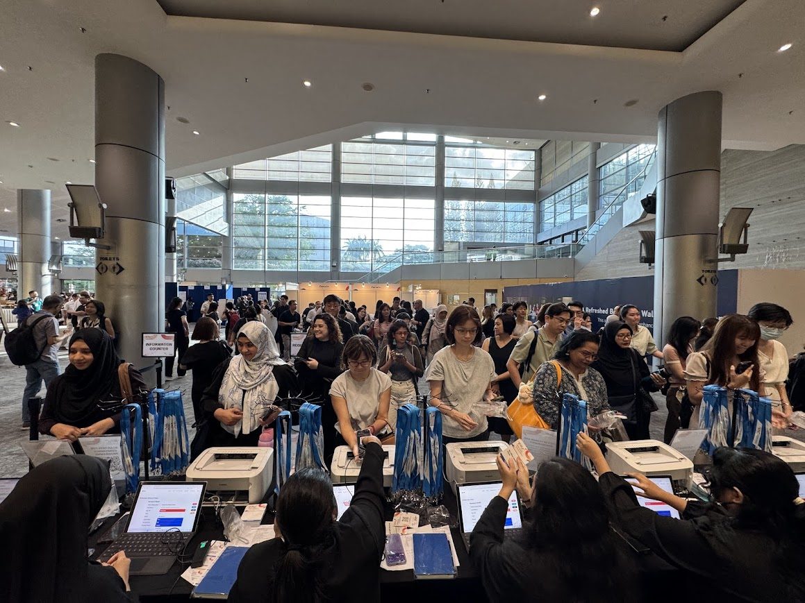 Busy onsite registration counter with QR code scanning and badge printing support