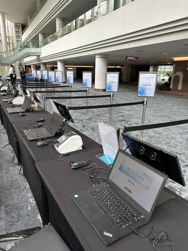 Registration equipment setup with laptops, scanners and onsite badge printers