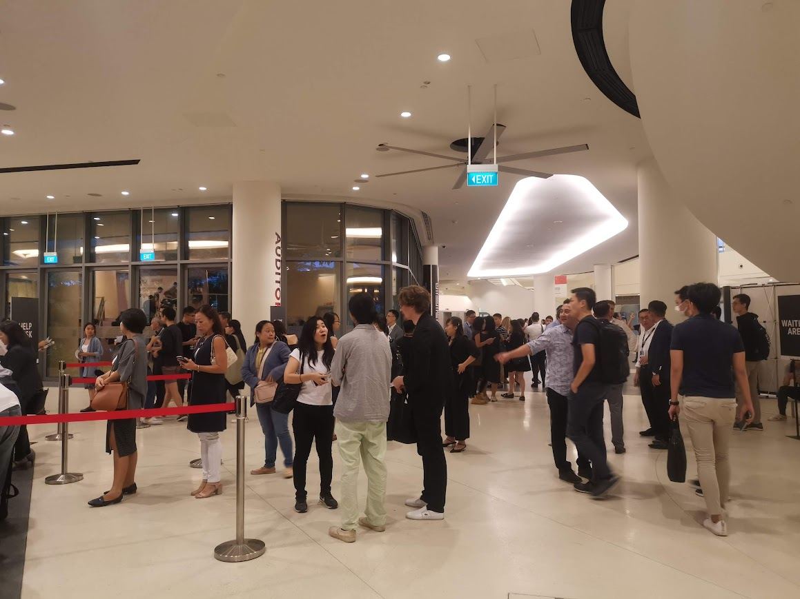 Attendees arriving at an event registration area with queue management and onsite support